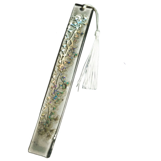 Off -white sparkly resin book mark covering multicoloured blue and pink rock crystals